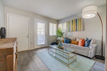Salt Lake City apartment for rent - A living room with a white couch and a glass coffee table.