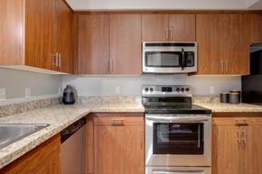 Avondale apartment for rent - A kitchen with wooden cabinets and a stainless steel oven.