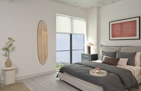 Charleston apartment for rent - a bedroom with a large window and a bed with pillows