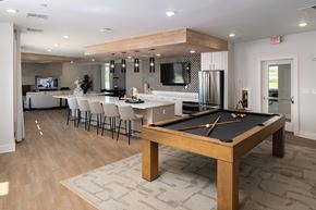Huntsville apartment for rent - A pool table is in the middle of a room with a kitchen in the background.