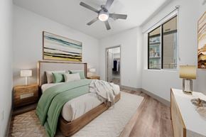 Tempe apartment for rent - A bedroom with a large bed and a ceiling fan.