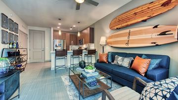 Tempe apartment for rent - A living room with a blue couch and a wooden coffee table.