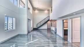 Tempe apartment for rent - A spacious interior with a marble floor and a staircase.