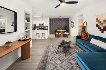 Decatur apartment for rent - A modern living room with a blue couch and a wooden coffee table.