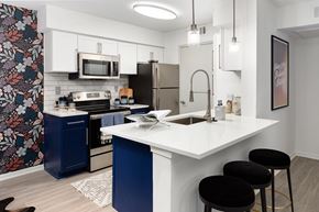 Sandy Springs apartment for rent - a kitchen with a white counter top and a stainless steel refrigerator