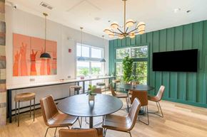 Lenexa apartment for rent - A modern dining room with a round table and chairs.