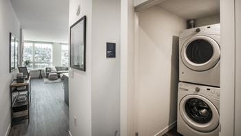 A washer and dryer stacked on top of each other in a small room.