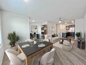 N Charleston apartment for rent - A dining room with a black table and white chairs.