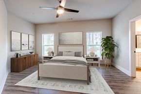 Johns Island apartment for rent - A bedroom with a large bed and a ceiling fan.