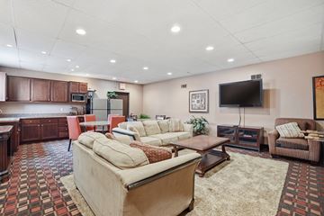 Vista apartment for rent - A living room with a large couch and a television.