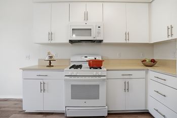 Kitchens with quartz countertops and white european cabinetry