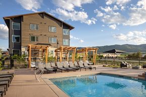 Littleton apartment for rent - A large house with a pool in front.