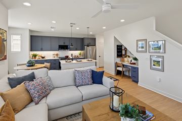 Menifee apartment for rent - A modern living room with a grey sofa and a wooden coffee table.