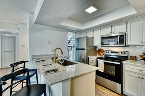 Mesa apartment for rent - an open kitchen with a marble counter top and a sink