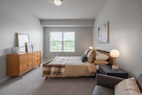 West Saint Paul apartment for rent - A bedroom with a bed, nightstand, and dresser.