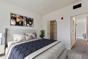Boise apartment for rent - A bedroom with a large bed and a carpeted floor.