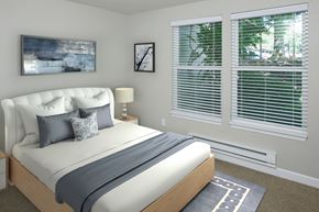 Lake Oswego apartment for rent - A bedroom with a large bed and a painting on the wall.