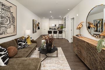 Atlanta apartment for rent - A living room with a brown couch and a large abstract painting on the wall.