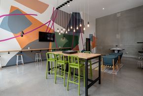 Minneapolis apartment for rent - A modern dining area with a wooden table and green chairs.