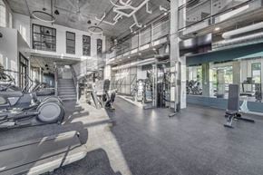 South Salt Lake apartment for rent - a gym floor with cardio equipment and a staircase