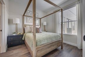 South Salt Lake apartment for rent - a bedroom with a four poster bed and a large window