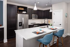 Norcross apartment for rent - A kitchen with a white counter top and blue chairs.