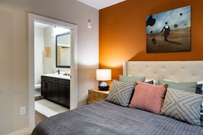 Norcross apartment for rent - A bedroom with a bed, nightstand, and a painting on the wall.
