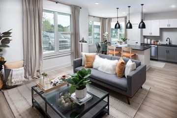 Austell apartment for rent - A modern living room with a grey sofa and a glass coffee table.