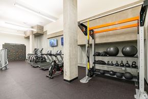 San Francisco apartment for rent - a gym with weights and a wall with a rock climbing wall