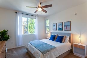 San Diego apartment for rent - A bedroom with a large bed and a ceiling fan.