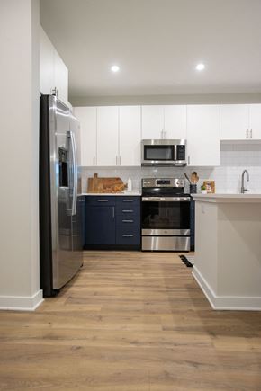 Cary apartment for rent - a kitchen with stainless steel appliances and white cabinets