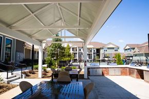 Mooresville apartment for rent - a covered patio with a table and chairs next to a pool