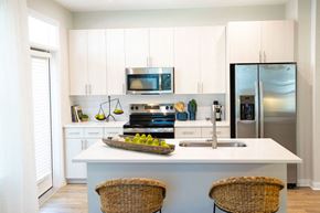 Mooresville apartment for rent - a kitchen with stainless steel appliances and white cabinets