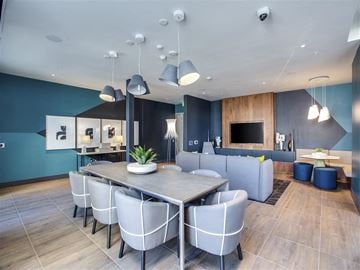 Long Beach apartment for rent - a dining room and living room with blue walls and white chairs