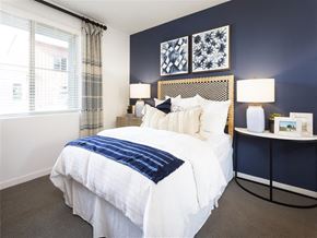 Montclair apartment for rent - A bedroom with a white bed and a blue blanket.