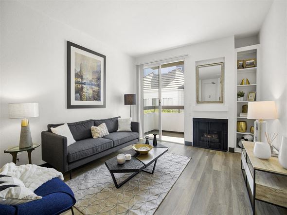 Paramount apartment for rent - a living room with a couch and a fire place at Enclave, Paramount, CA