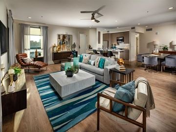 Santa Monica apartment for rent - A living room with a blue rug and a brown chair.