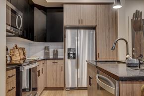 Salt Lake City apartment for rent - a kitchen with wooden cabinets and a stainless steel refrigerator