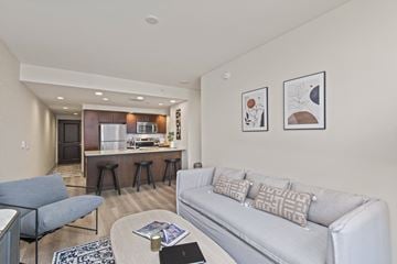 Seattle apartment for rent - A living room with a grey couch and a coffee table.
