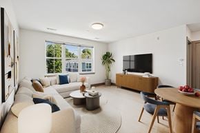 Beverly apartment for rent - A modern living room with a large window and a flat screen TV.