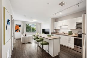 Beverly apartment for rent - A modern kitchen with white cabinets and a large island.