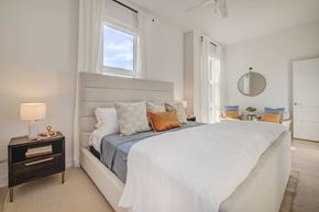 Salt Lake City apartment for rent - a white bedroom with a large bed and a window