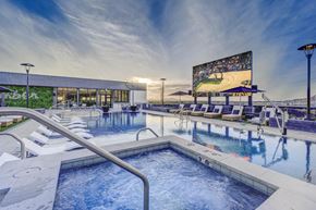 Salt Lake City apartment for rent - a swimming pool with lounge chairs and a movie screen at the resort at governors crossing