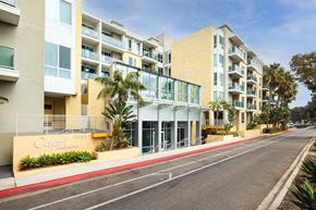 Marina Del Rey apartment for rent - A street view of a Cayman Apartments building with a clear blue sky above.