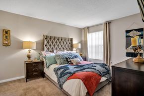 Orlando apartment for rent - our apartments offer a bedroom with a king sized bed  at Castilian Apartments, Orlando, FL, 32839