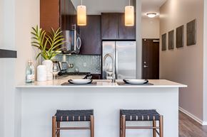Chicago apartment for rent - A kitchen with a white counter top and two stools.