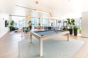 Chicago apartment for rent - A pool table in a room with a view of the city.
