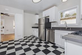San Leandro apartment for rent - a kitchen with a checkered floor and a stainless steel refrigerator