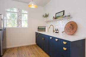 Tempe apartment for rent - a kitchen with white walls and blue cabinets