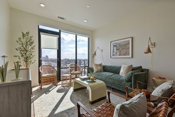Richmond apartment for rent - A living room with a green couch and a wooden coffee table.